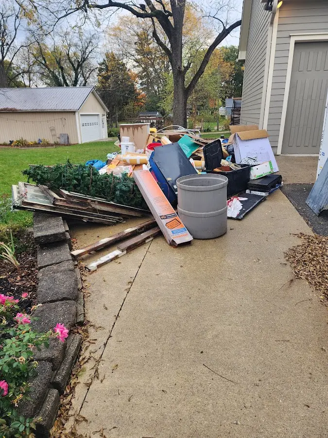 Dumpster being loaded with debris for Commercial Dumpster Rental in Lake George